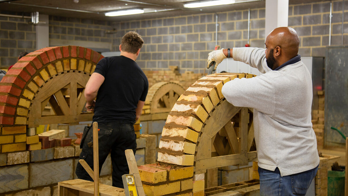 Practical bricklaying training in a construction workshop